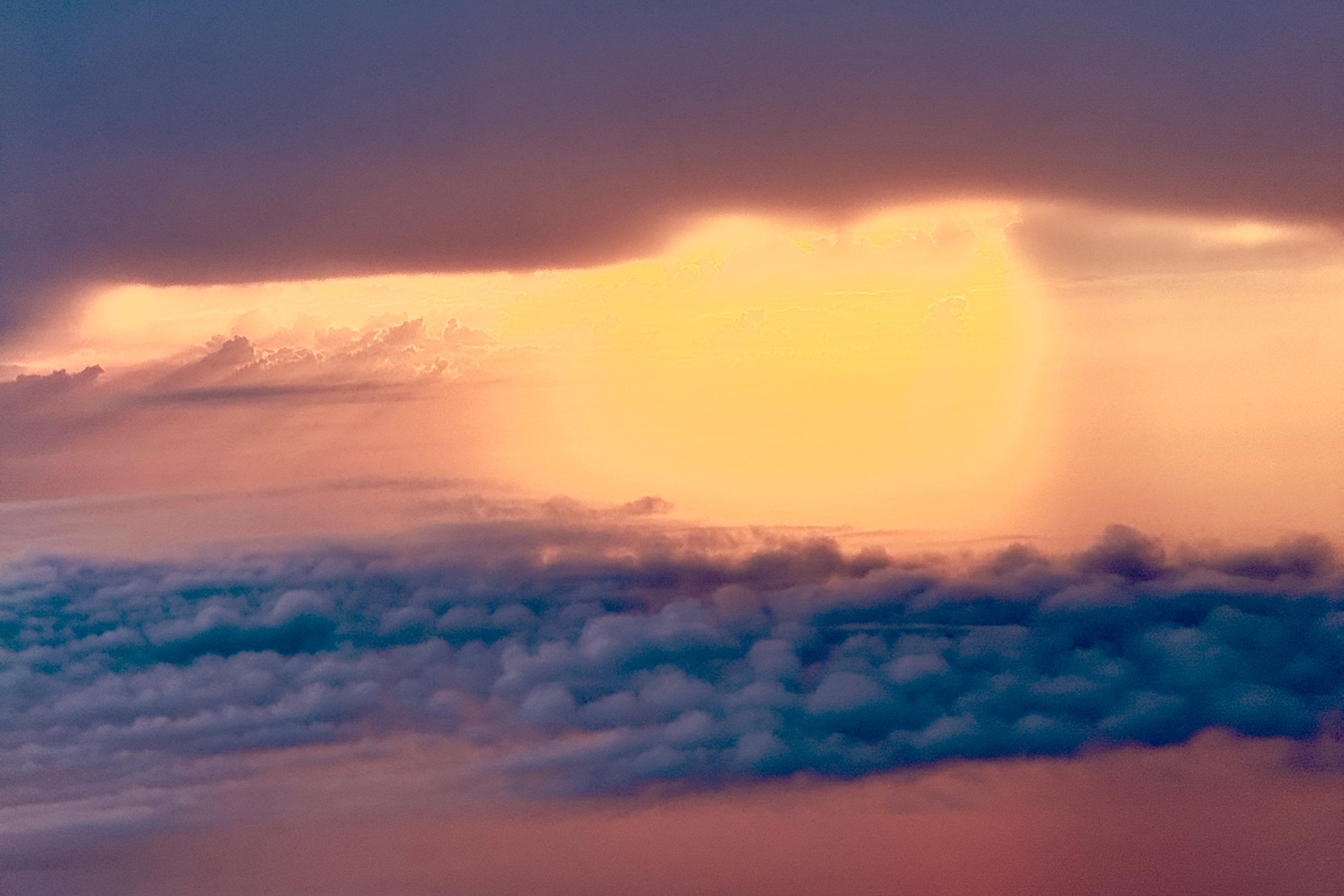 Sunlight breaking through dark clouds over a landscape